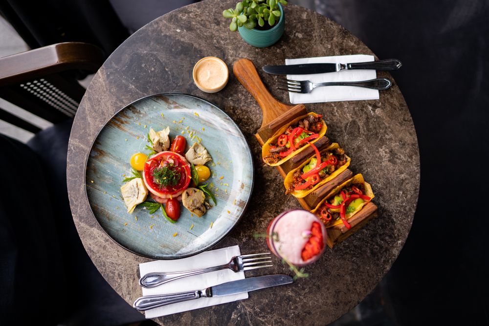 Colorful tacos and salad on a restaurant table
